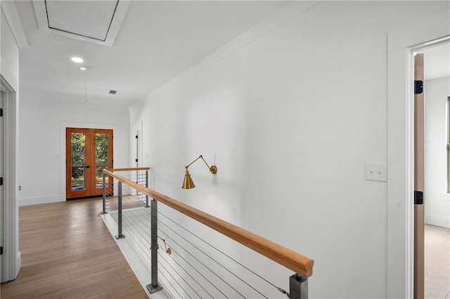 hallway featuring french doors and light hardwood / wood-style flooring