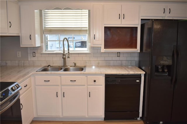 kitchen featuring black appliances, backsplash, white cabinetry, and sink