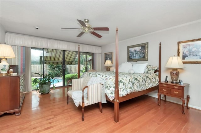 bedroom featuring light wood-type flooring, a ceiling fan, and ornamental molding
