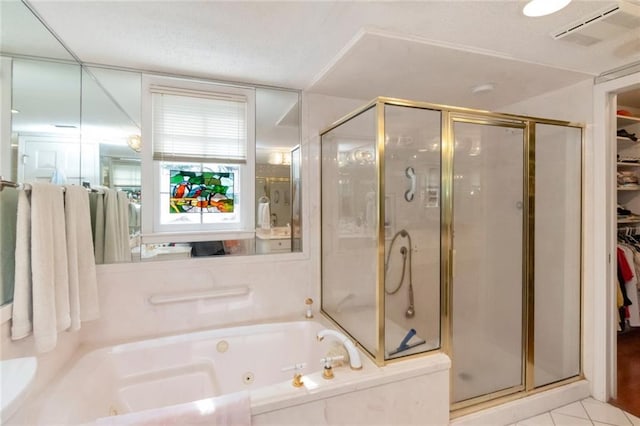bathroom featuring a shower stall, a spacious closet, tile patterned floors, a jetted tub, and visible vents