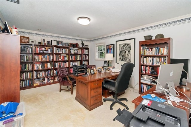 home office featuring wall of books, carpet floors, a textured ceiling, and ornamental molding