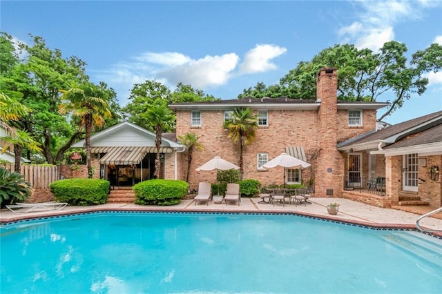 view of swimming pool featuring fence, a patio area, and a fenced in pool