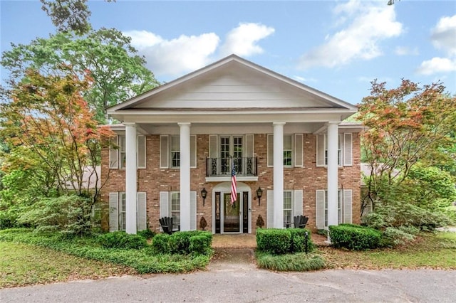 view of front of property featuring brick siding and a porch
