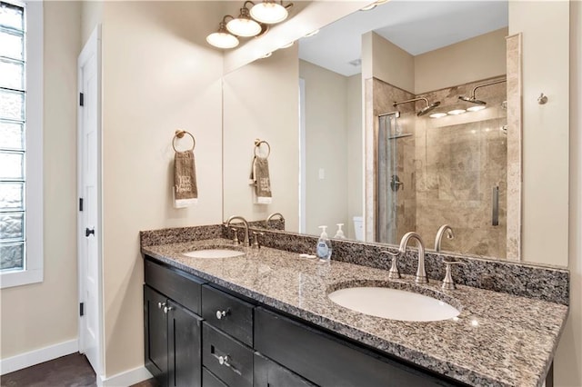 bathroom featuring vanity, a healthy amount of sunlight, and walk in shower