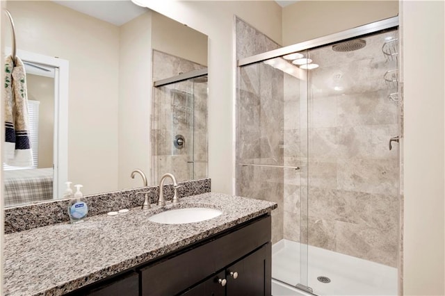 bathroom with vanity and a shower with door