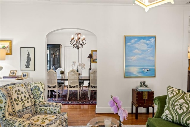 159 Roberts St, Mobile, AL 36604 - living room with arched walkways, a chandelier, wood finished floors, and ornamental molding