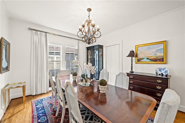 159 Roberts St, Mobile, AL 36604 - dining room with a chandelier, light wood-style floors, and crown molding
