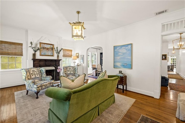 159 Roberts St, Mobile, AL 36604 - living area with arched walkways, healthy amount of natural light, a fireplace, and ornamental molding