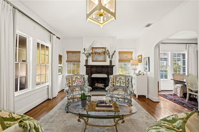 159 Roberts St, Mobile, AL 36604 - living area with arched walkways, wood finished floors, and a fireplace
