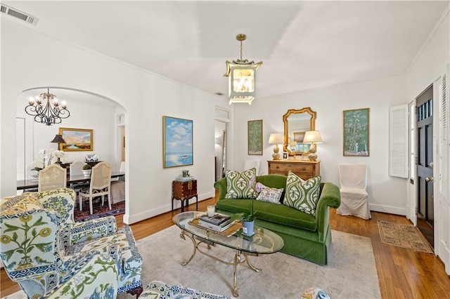 159 Roberts St, Mobile, AL 36604 - living area with a chandelier, arched walkways, wood finished floors, and crown molding