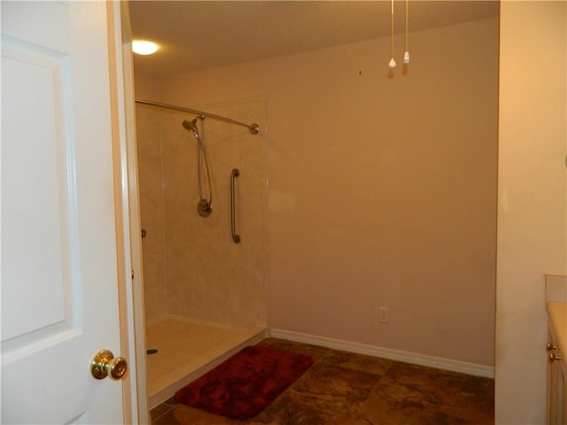 bathroom featuring tiled shower, vanity, and tile patterned floors