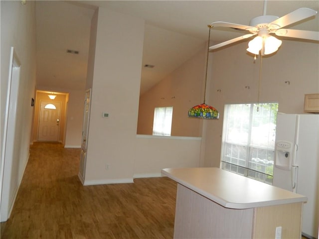 kitchen with light hardwood / wood-style floors, white refrigerator with ice dispenser, ceiling fan, and high vaulted ceiling