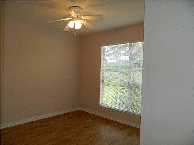 spare room with hardwood / wood-style flooring and ceiling fan