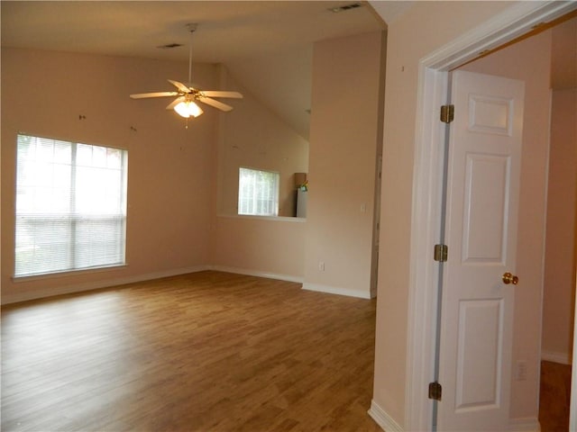 interior space featuring a healthy amount of sunlight, light hardwood / wood-style flooring, ceiling fan, and vaulted ceiling