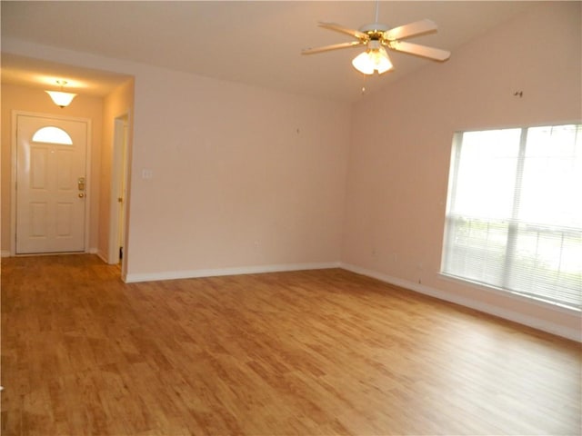 unfurnished living room with vaulted ceiling, light wood-type flooring, and ceiling fan