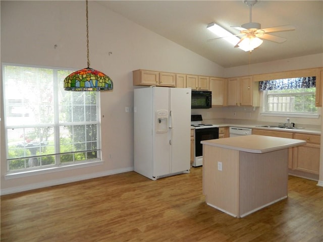 kitchen featuring a wealth of natural light, white appliances, and light hardwood / wood-style floors