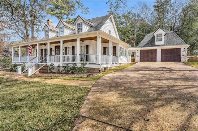 view of front facade featuring ceiling fan, a porch, a garage, an outdoor structure, and a front lawn