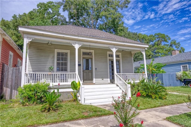 bungalow-style home with a front lawn and covered porch