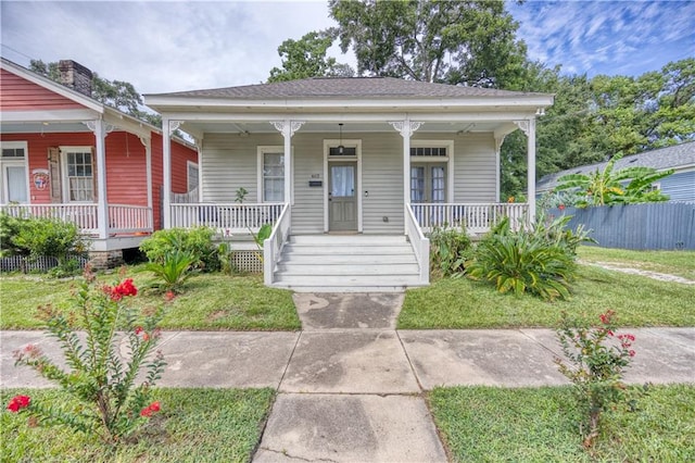 bungalow featuring a front lawn and covered porch