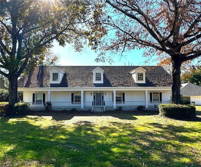 cape cod house with a front yard and a porch