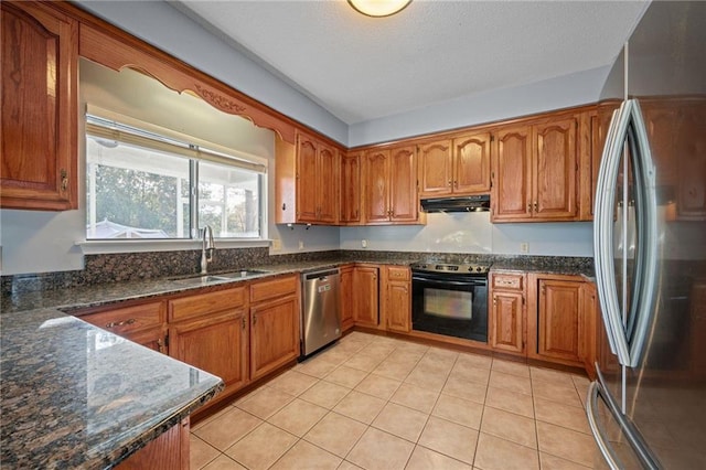 kitchen featuring dark stone counters, ventilation hood, stainless steel appliances, sink, and light tile patterned flooring