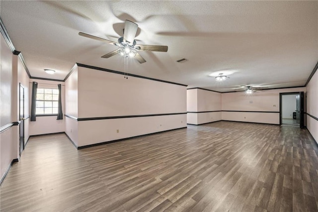 unfurnished room featuring hardwood / wood-style floors, a textured ceiling, ceiling fan, and crown molding