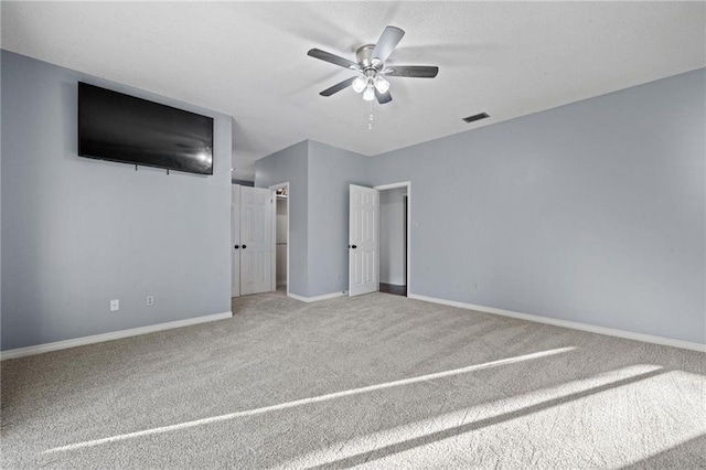 unfurnished bedroom with carpet floors and ceiling fan