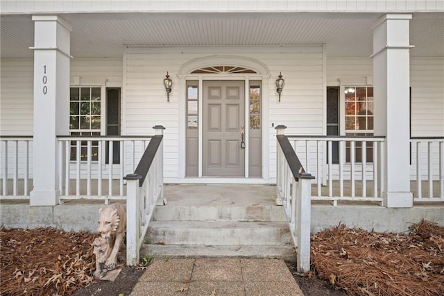 view of exterior entry with a porch