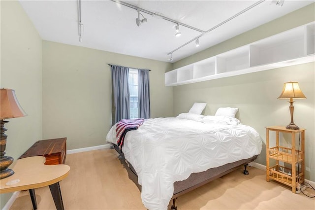 5721 Long Meadow Rd, Mobile, AL 36609 - bedroom featuring baseboards, rail lighting, and wood finished floors