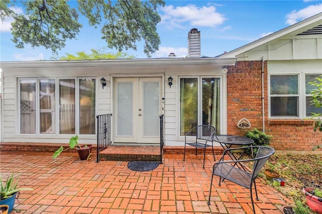 5721 Long Meadow Rd, Mobile, AL 36609 - property entrance featuring a patio area, brick siding, and a chimney