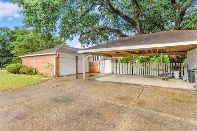 5721 Long Meadow Rd, Mobile, AL 36609 - view of front of house featuring a gate, brick siding, a detached garage, and a carport