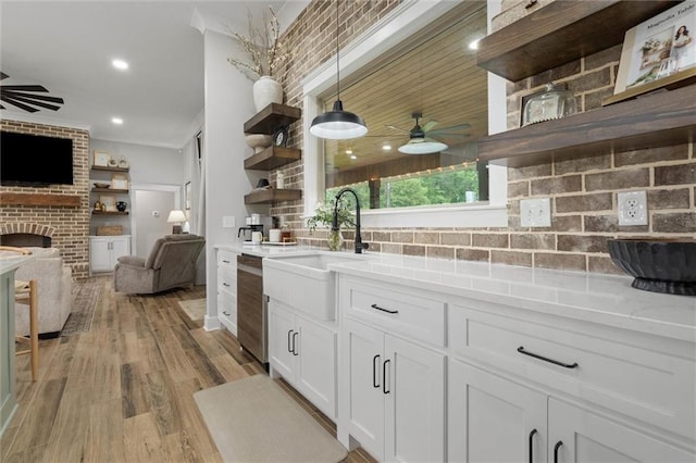 kitchen with open shelves, open floor plan, ceiling fan, and a sink