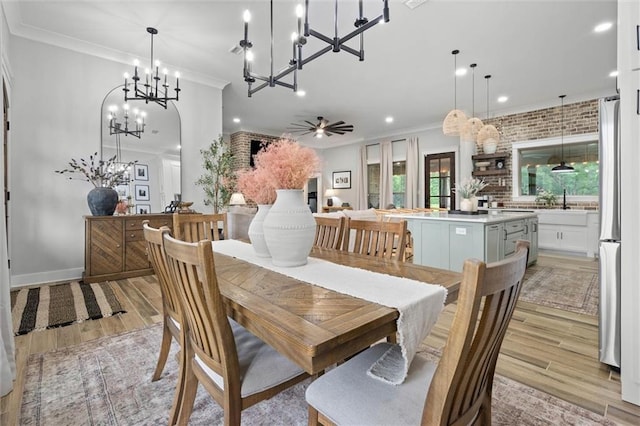 dining area featuring ornamental molding, light wood-style flooring, recessed lighting, and ceiling fan with notable chandelier