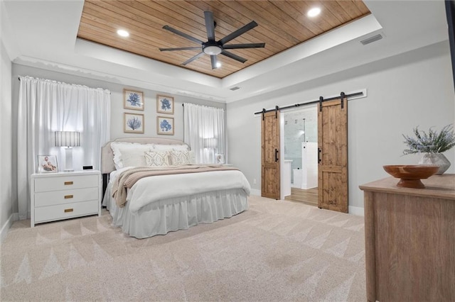carpeted bedroom with wood ceiling, a tray ceiling, a barn door, baseboards, and recessed lighting