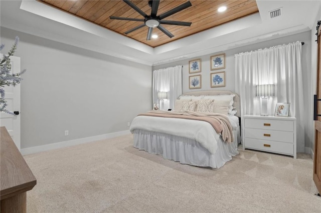 bedroom featuring carpet flooring, a tray ceiling, visible vents, and wooden ceiling