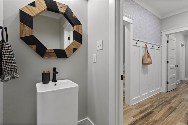 bathroom with wood finished floors and baseboards