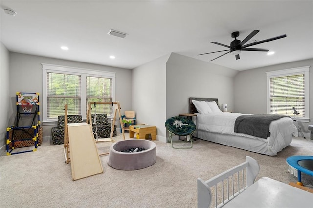 carpeted bedroom featuring recessed lighting, a ceiling fan, visible vents, and multiple windows