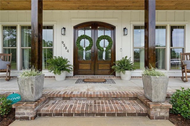 entrance to property featuring covered porch and french doors