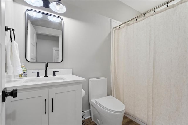 full bath featuring toilet, wood finished floors, vanity, and a shower with curtain