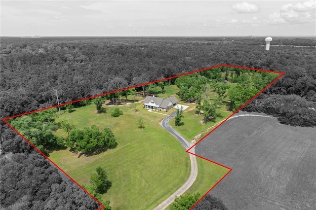 drone / aerial view featuring a wooded view