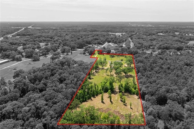 drone / aerial view featuring a wooded view