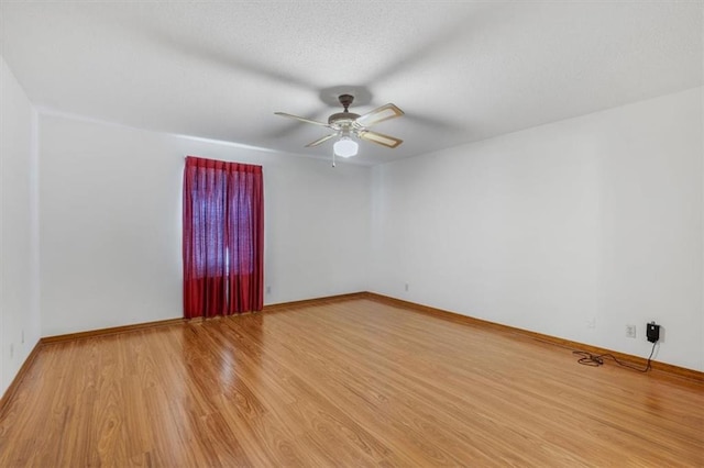 spare room featuring ceiling fan and hardwood / wood-style flooring