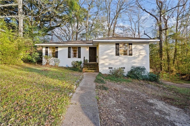 view of front of home featuring crawl space, a front lawn, and brick siding