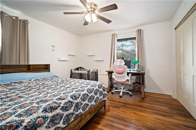 bedroom featuring dark wood-type flooring, a closet, a ceiling fan, and baseboards