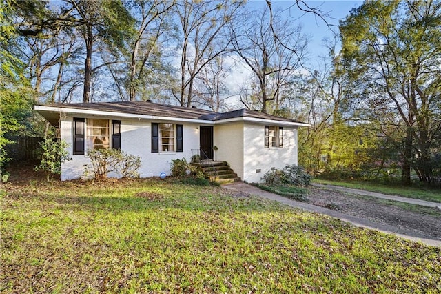 view of front of house featuring a front yard, crawl space, and brick siding