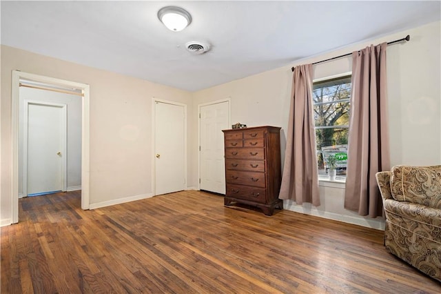 interior space with visible vents, dark wood finished floors, and baseboards