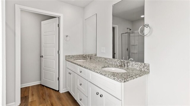 8616 Brooklyn Ct, Semmes, AL 36575 - bathroom featuring double vanity, a shower with door, and wood finished floors