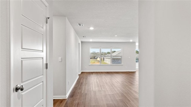 8616 Brooklyn Ct, Semmes, AL 36575 - corridor featuring wood finished floors, a textured ceiling, and recessed lighting