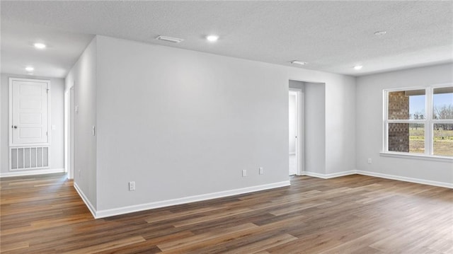 8616 Brooklyn Ct, Semmes, AL 36575 - spare room featuring wood finished floors, a textured ceiling, and recessed lighting