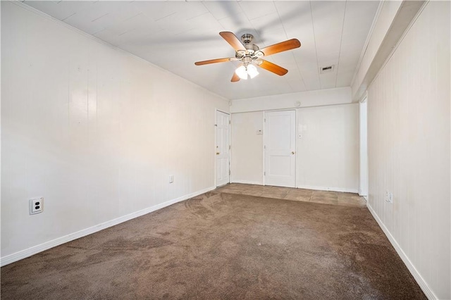 empty room featuring ceiling fan, carpet floors, and ornamental molding